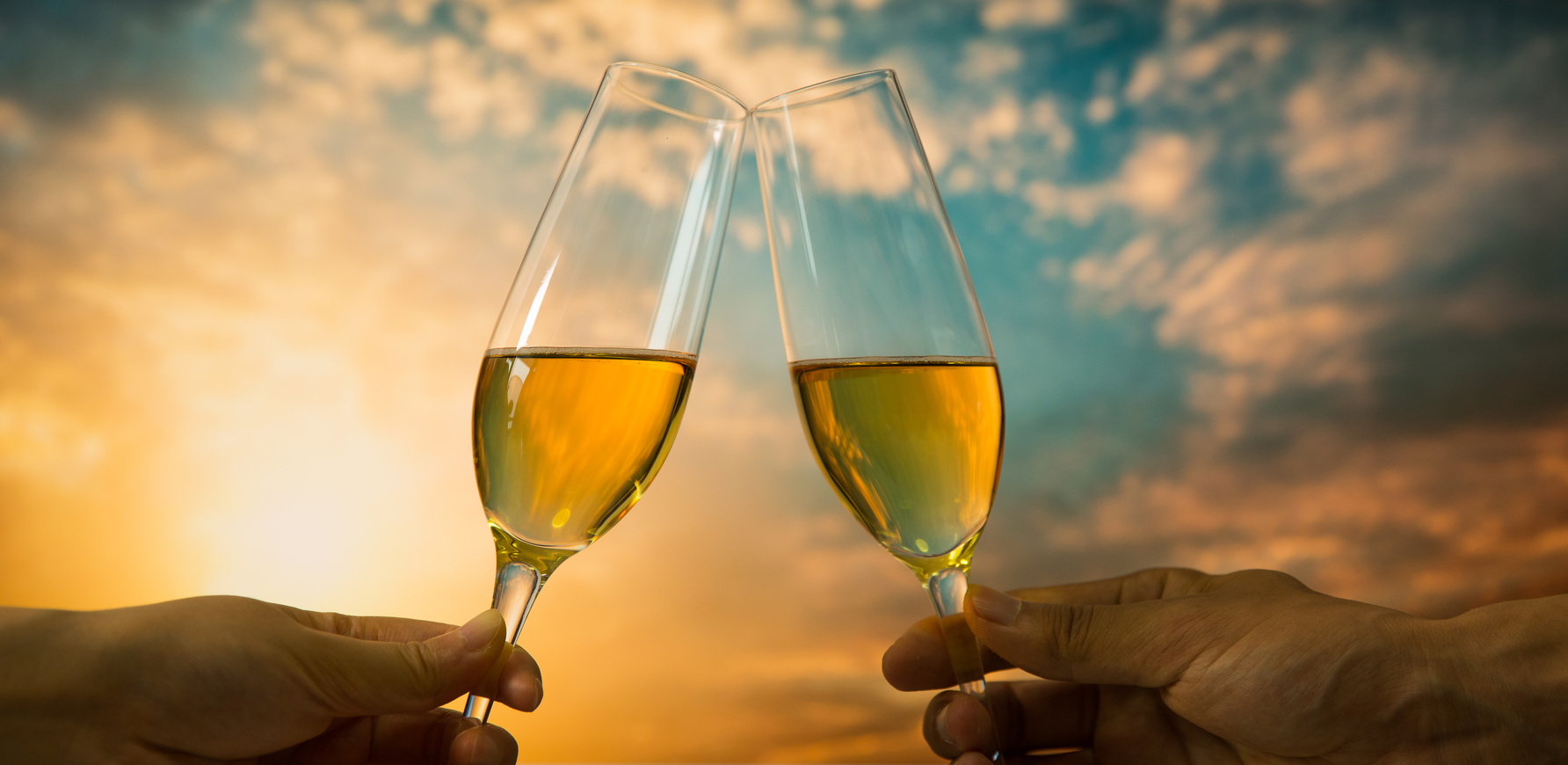 Couple drinking champagne at sunset